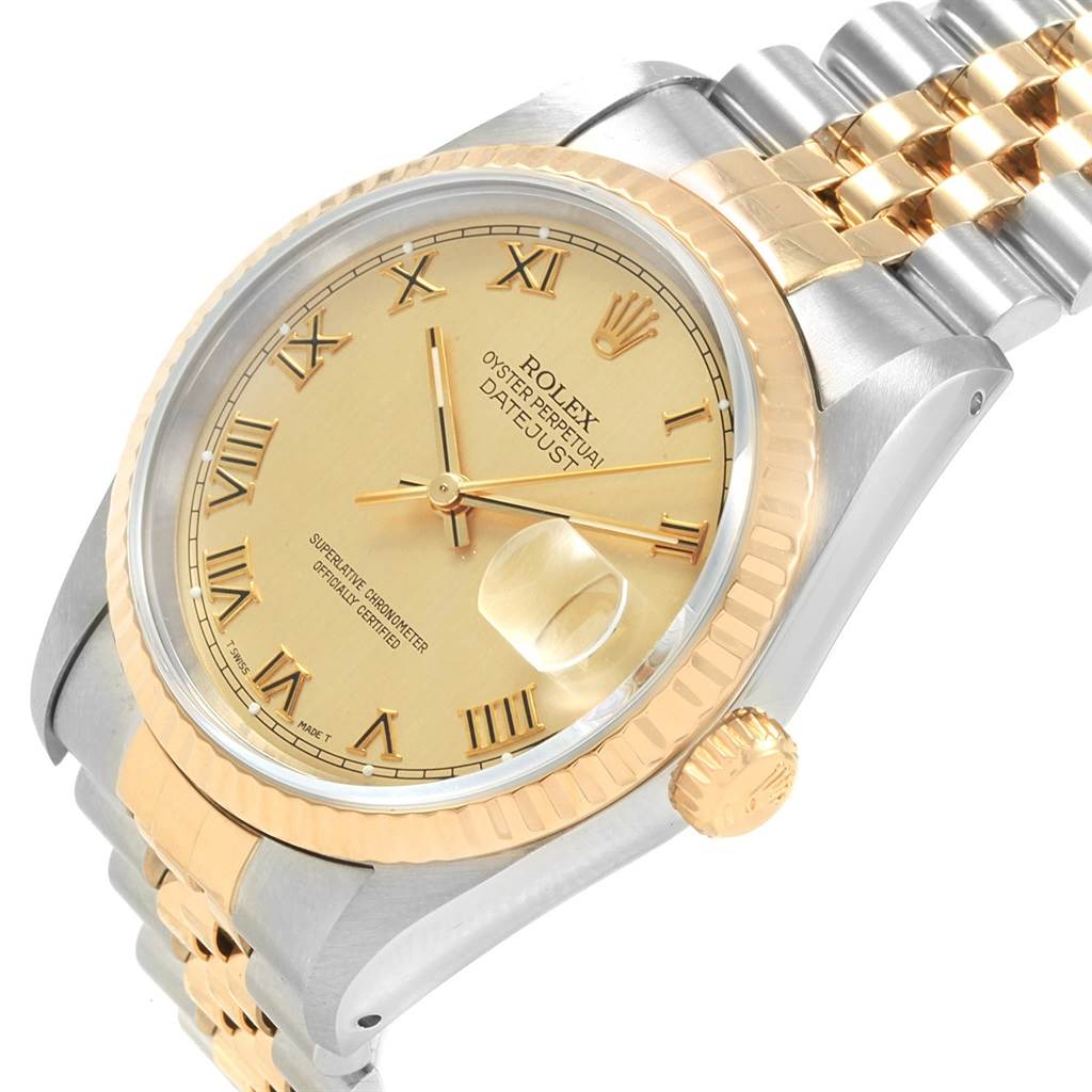 The image shows a close-up of the Rolex Datejust 16233 Men
s Steel and Gold (two tone) Champagne Dial 16233 Men
s Steel and Gold (two tone) Champagne Dial watch
s dial, fluted bezel, crown, and two-tone bracelet at an angle.