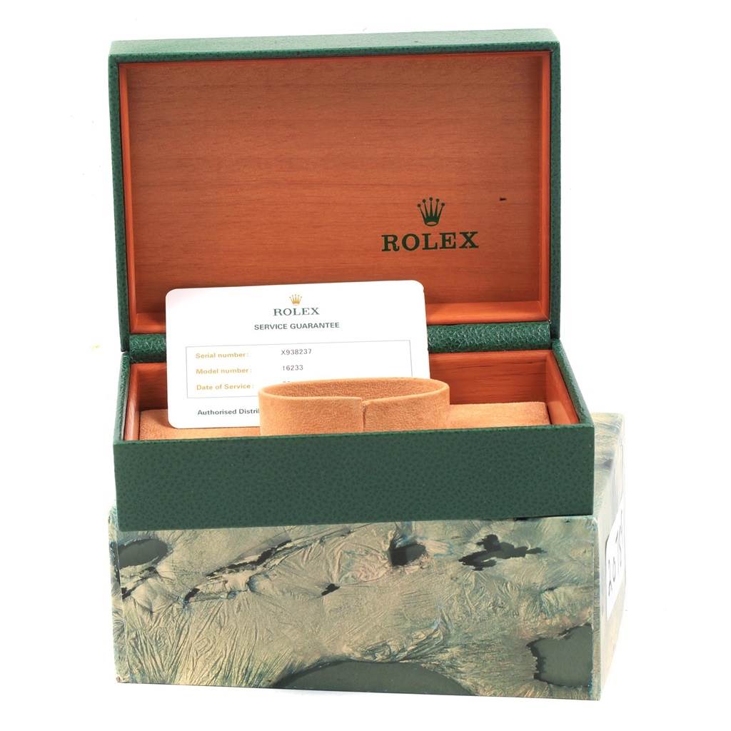 This image shows an open Rolex Datejust 16233 Men
s Steel and Gold (two tone) Champagne Dial 16233 Men
s Steel and Gold (two tone) Champagne Dial watch box including a service guarantee card and a watch cushion.