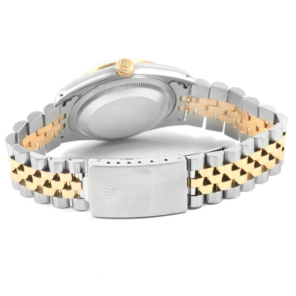 The image shows the back of the Rolex Datejust 16233 Men
s Steel and Gold (two tone) Champagne Dial 16233 Men
s Steel and Gold (two tone) Champagne Dial watch and its two-tone bracelet and clasp.