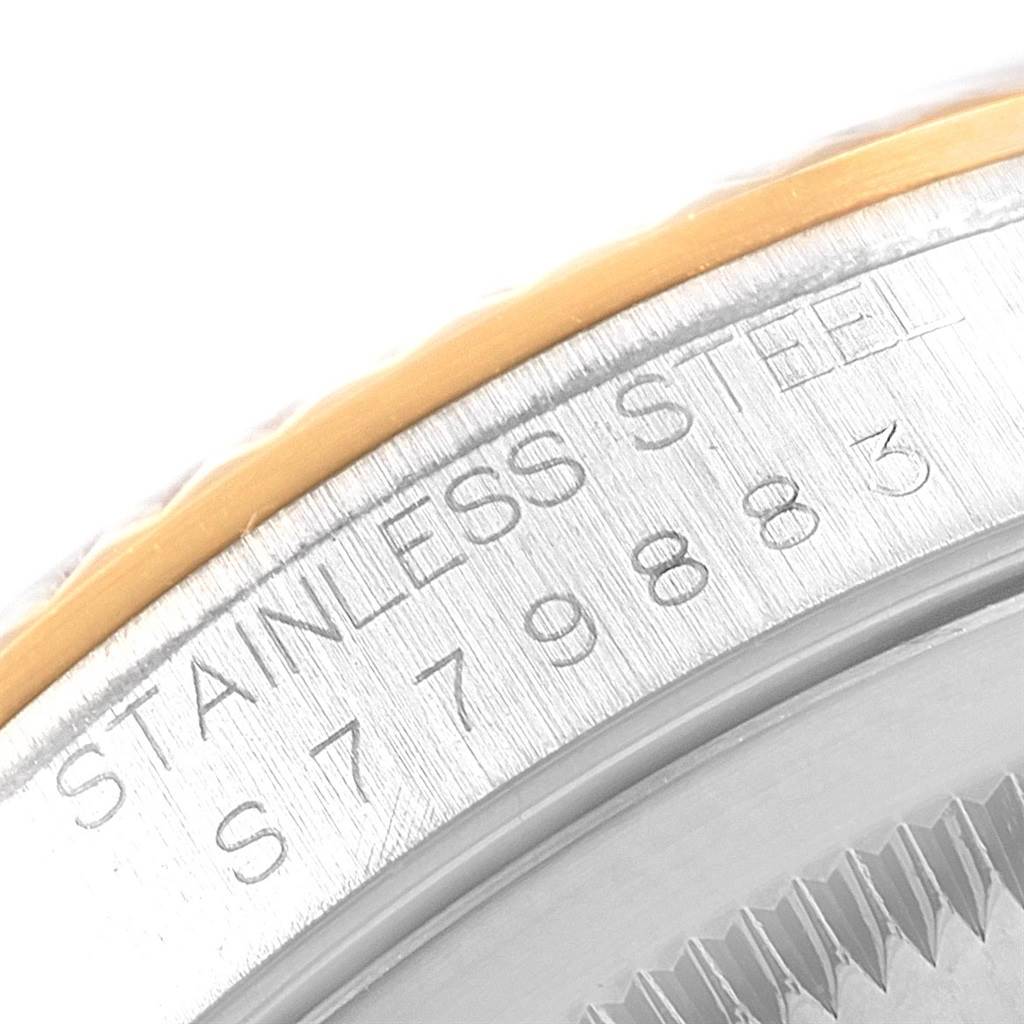 The image shows a close-up of the case and bezel of a Rolex Datejust 16233 Men's Steel and Gold (two tone) Blue Dial 16233 Men's Steel and Gold (two tone) Blue Dial watch, highlighting the stainless steel material and serial number.