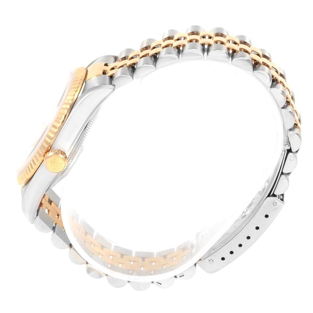 The image shows a side view of a Rolex Datejust 16233 Men's Steel and Gold (two tone) Beige Dial 16233 Men's Steel and Gold (two tone) Beige Dial watch, highlighting the gold fluted bezel, crown, and two-tone metal bracelet.