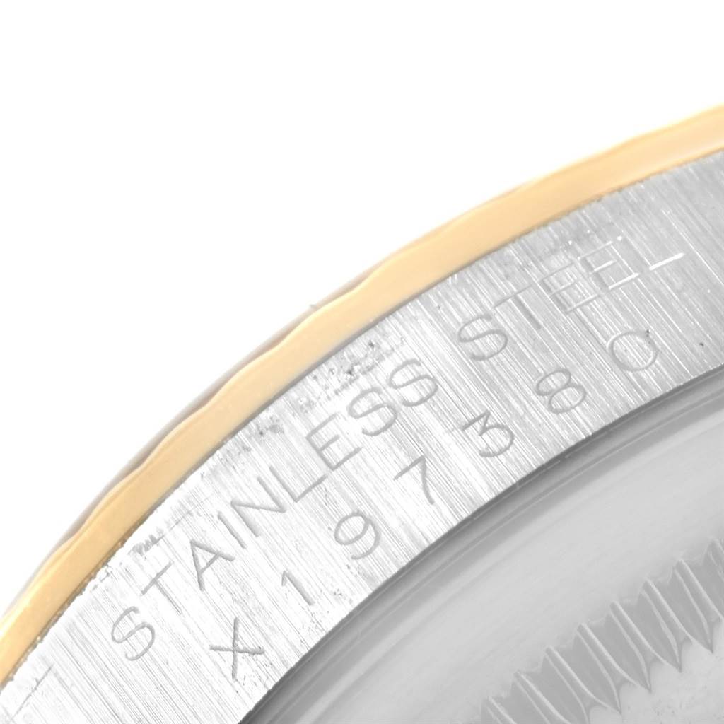 The image shows a close-up of the side of a Rolex Datejust 16233 Men's Steel and Gold (two tone) Blue Dial 16233 Men's Steel and Gold (two tone) Blue Dial model watch case, highlighting the "STAINLESS STEEL" engraving.