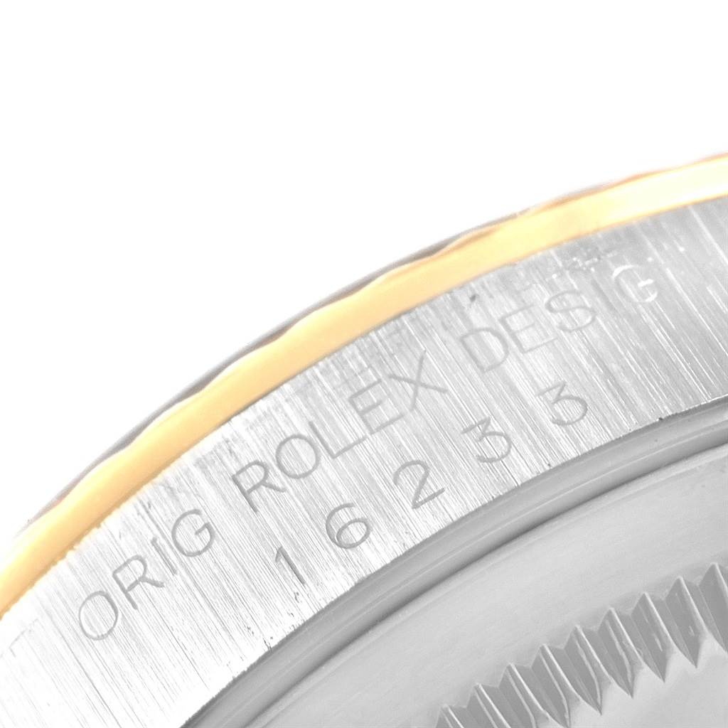 This close-up image shows the engraved edge of the bezel of a Rolex Datejust 16233 Men's Steel and Gold (two tone) Blue Dial 16233 Men's Steel and Gold (two tone) Blue Dial watch.