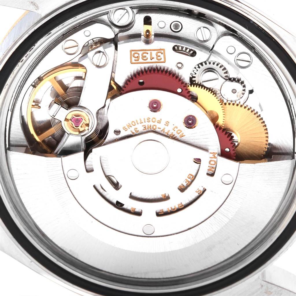 The image shows the internal mechanism of a Rolex Datejust 16233 Men's Steel and Gold (two tone) Blue Dial 16233 Men's Steel and Gold (two tone) Blue Dial watch, viewed from the back, highlighting gears and movement components.