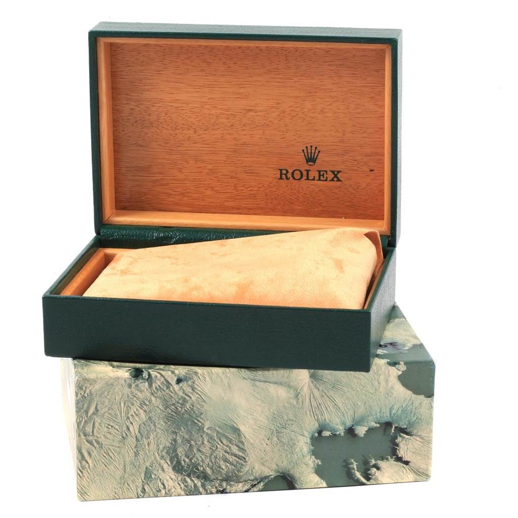 The image shows the open box of a Rolex Datejust 16233 Men's Steel and Gold (two tone) Champagne Dial 16233 Men's Steel and Gold (two tone) Champagne Dial watch with a green exterior and wooden interior.