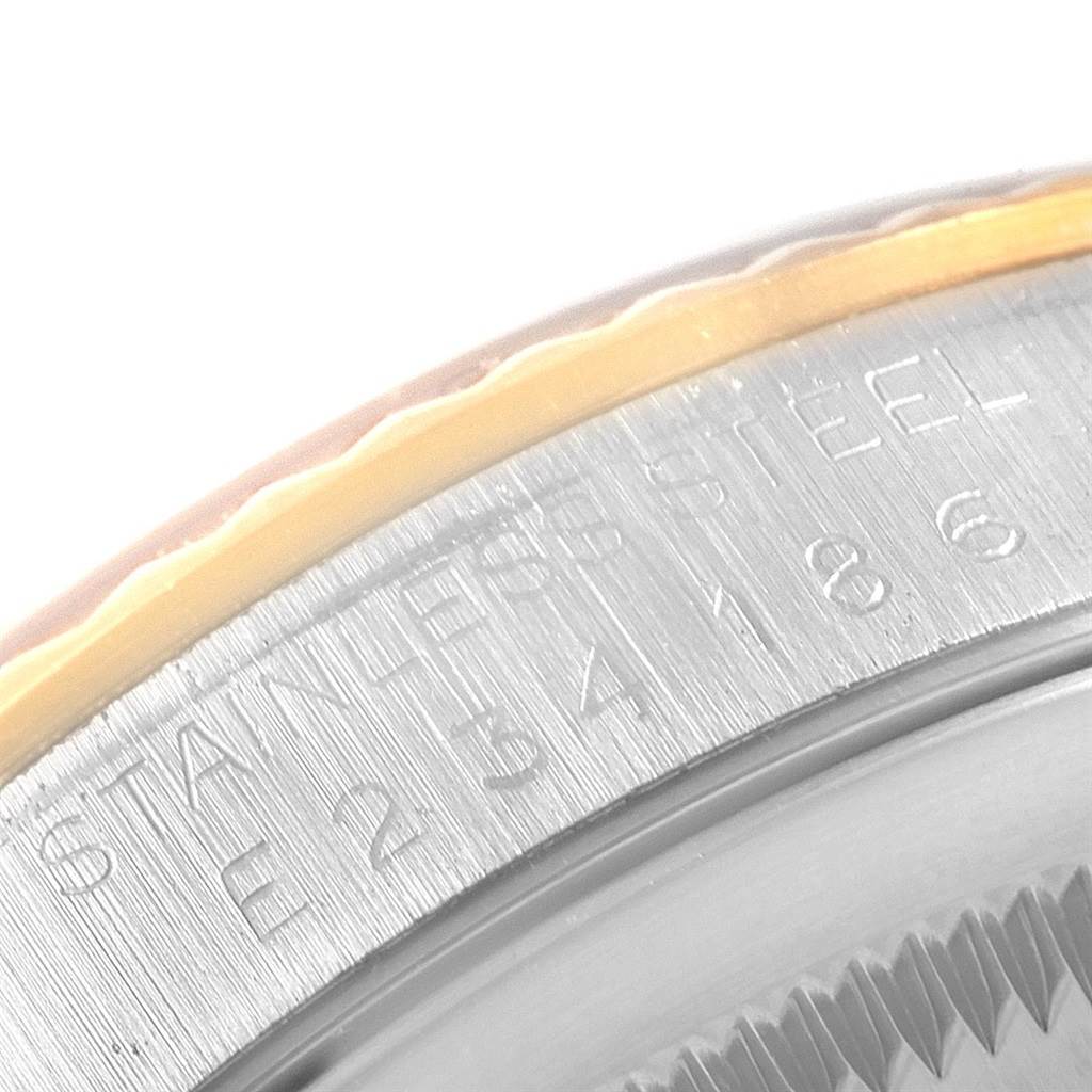 This close-up image shows the engraved bezel and outer edge of the dial of the Rolex Datejust 16233 Men's Steel and Gold (two tone) Champagne Dial 16233 Men's Steel and Gold (two tone) Champagne Dial watch, highlighting "STAINLESS STEEL."