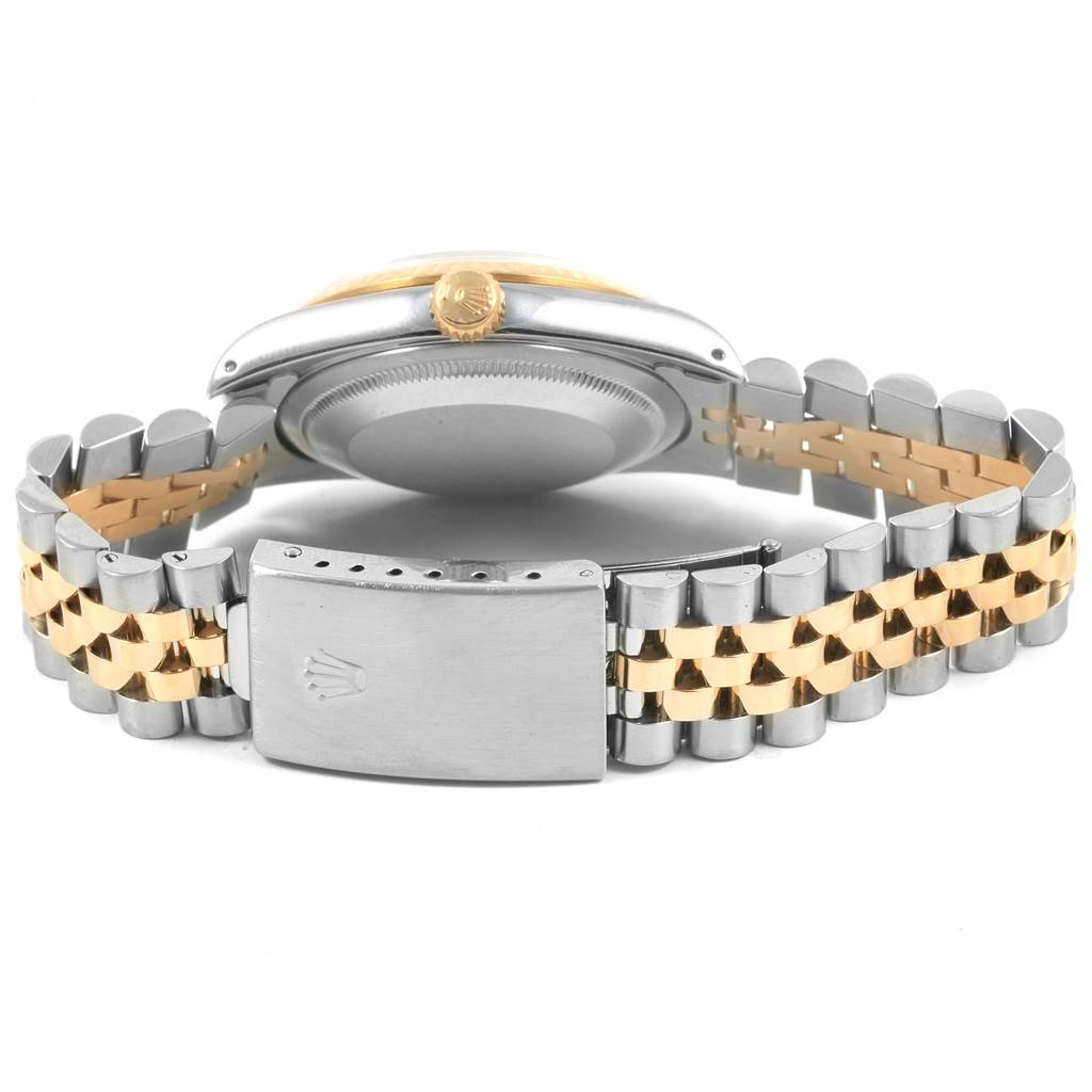 This image shows the backside of a Rolex Datejust 16233 Men's Steel and Gold (two tone) Champagne Dial 16233 Men's Steel and Gold (two tone) Champagne Dial watch, highlighting the clasp and part of the strap.