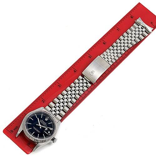 The image shows a top-down view of a Rolex Datejust 16234 Men's Stainless Steel Black Dial 16234 Men's Stainless Steel Black Dial watch, including the dial, bracelet, and clasp, placed alongside a red ruler.