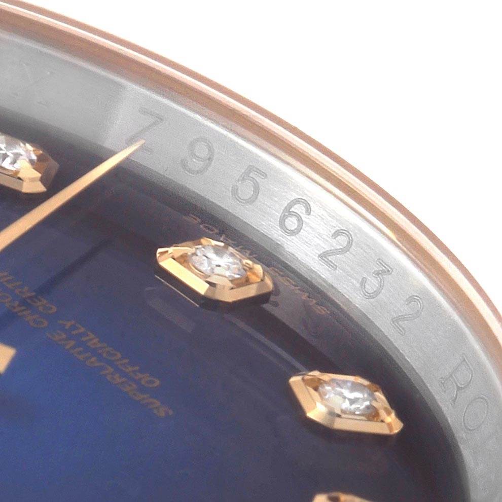 This close-up image of the Rolex Datejust 116233 Men's Stainless Steel Blue Dial 116233 Men's Stainless Steel Blue Dial shows part of the dial, diamonds, and serial number engraved on the rehaut.