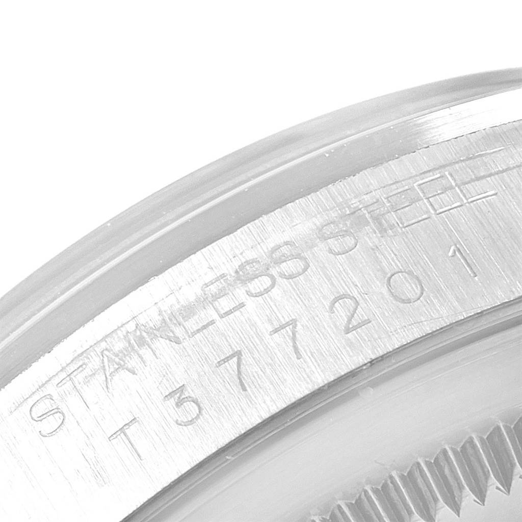 The image shows a close-up of the stainless steel bezel with engraved text from the Rolex Datejust 16200 Men's Stainless Steel Silver Dial 16200 Men's Stainless Steel Silver Dial model.