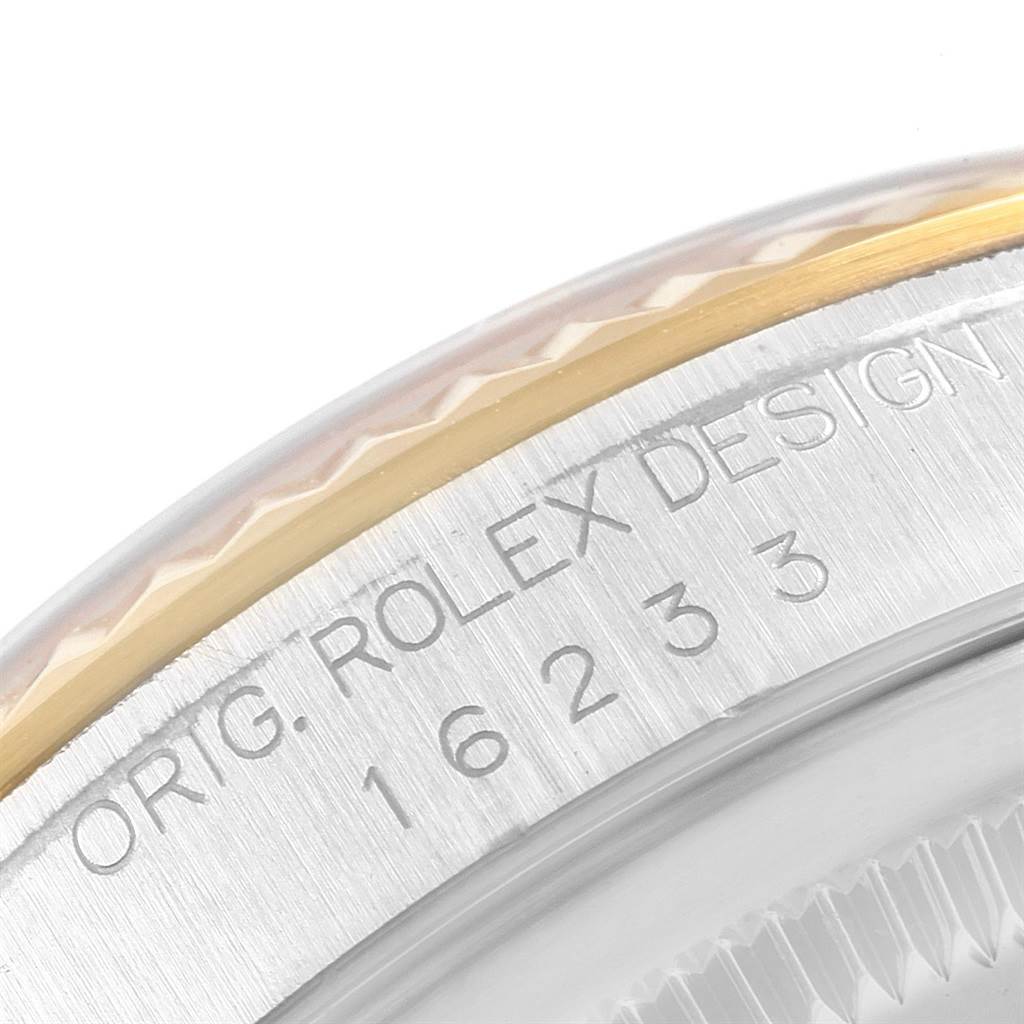 This image shows a close-up of the marked bezel and edge of the case of a Rolex Datejust 16233 Men's Steel and Gold (two tone) Black Dial 16233 Men's Steel and Gold (two tone) Black Dial watch.