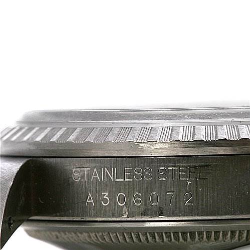 This image shows a close-up of the side of a Rolex Datejust 16220 Men's Stainless Steel White Dial 16220 Men's Stainless Steel White Dial model with visible serial number engraving and part of the bezel.