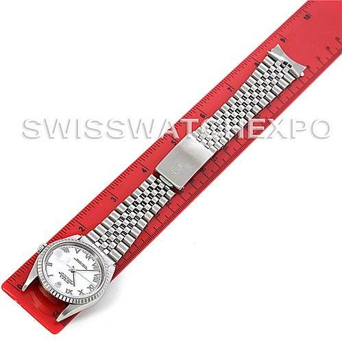 The image shows a top-down view of a Rolex Datejust 16220 Men's Stainless Steel White Dial 16220 Men's Stainless Steel White Dial watch with a silver bracelet laid flat on a red ruler.