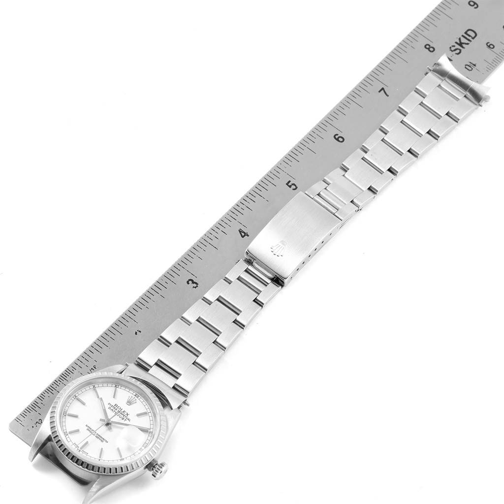 The image shows a Rolex Datejust 16220 Men's Stainless Steel White Dial 16220 Men's Stainless Steel White Dial watch, displaying the face, bezel, and full bracelet alongside a ruler.