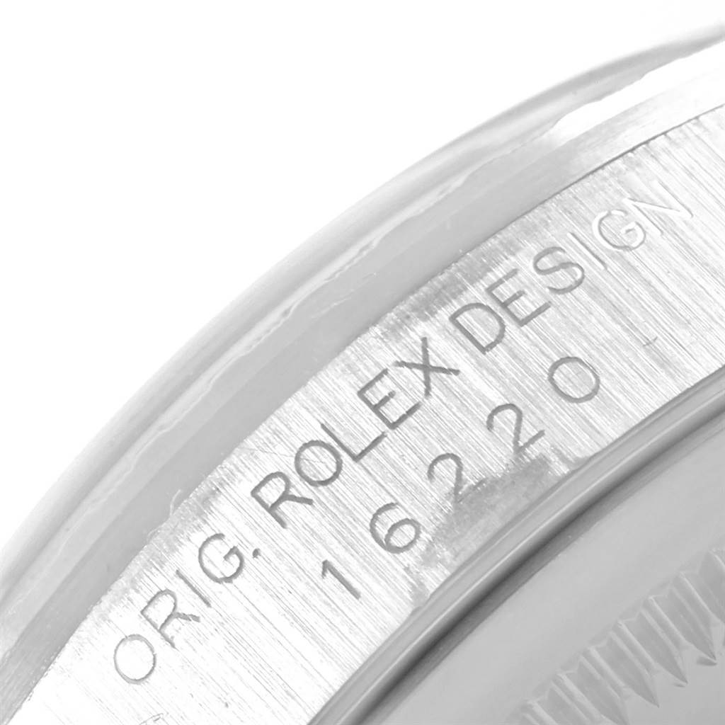 This image shows a close-up view of the case side of a Rolex Datejust 16220 Men's Stainless Steel White Dial 16220 Men's Stainless Steel White Dial watch, focusing on the engraved text and reference number.
