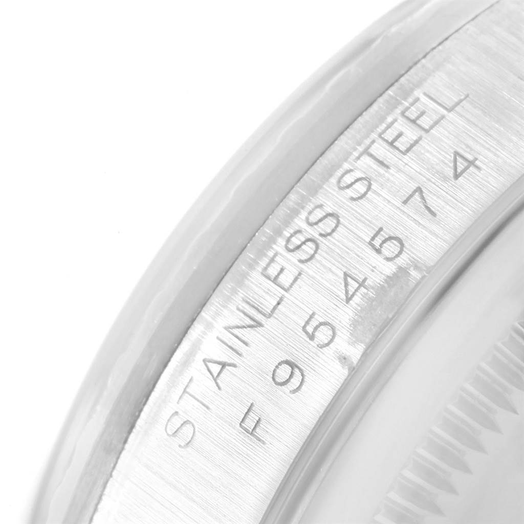 This close-up image shows the serial number and "Stainless Steel" inscription on the case of a Rolex Datejust 16220 Men's Stainless Steel White Dial 16220 Men's Stainless Steel White Dial watch.