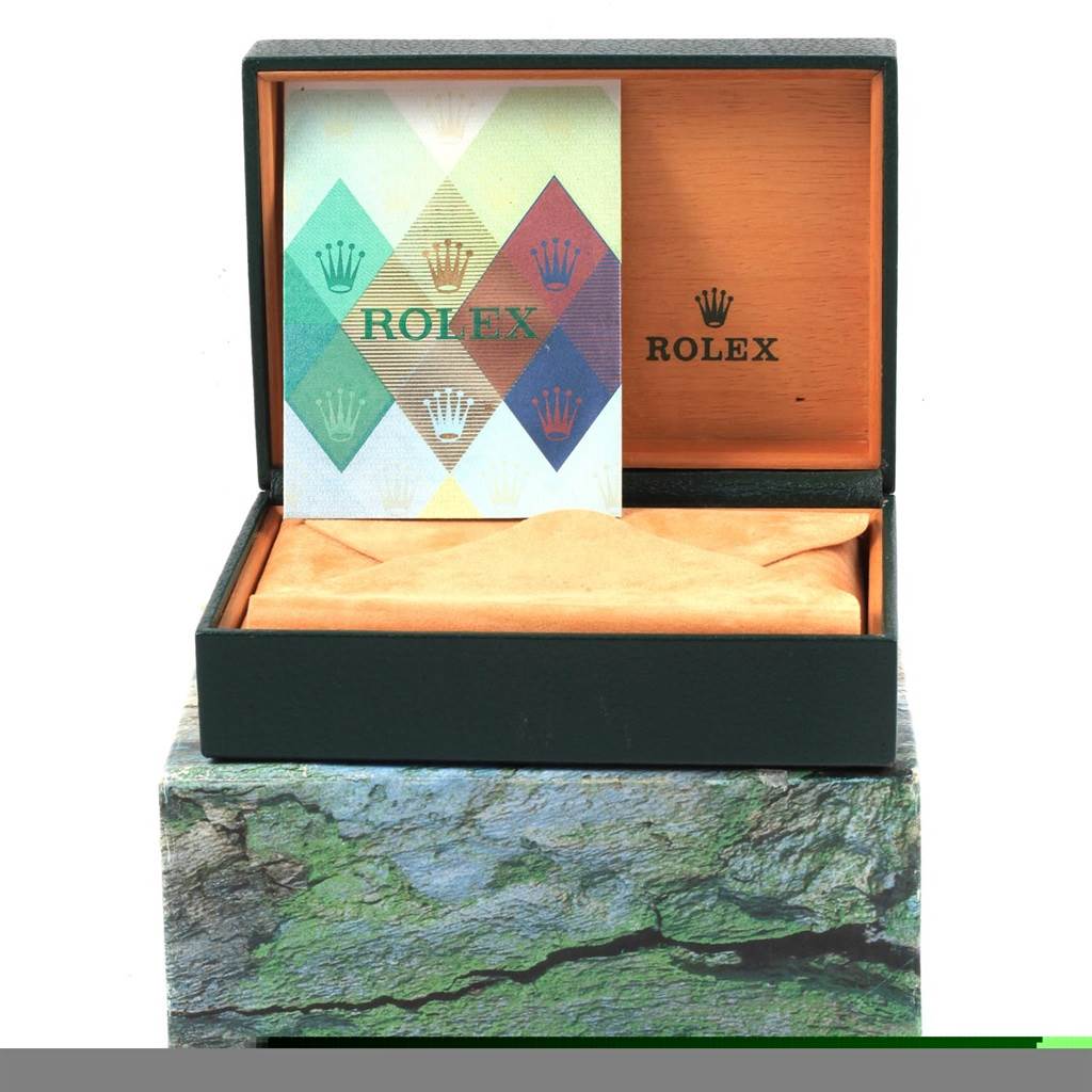 This image shows a Rolex Datejust 16220 Men's Stainless Steel White Dial 16220 Men's Stainless Steel White Dial watch box with the instruction manual inside, an empty cushion, and outer ornamental packaging.