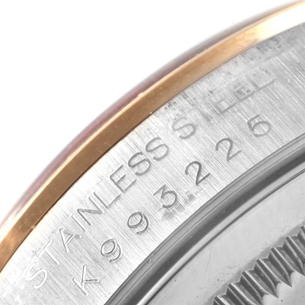 This close-up image shows the engraved bezel and part of the rim of a Rolex Datejust 16203 Men's Steel and Gold (two tone) Mother of Pearl Dial 16203 Men's Steel and Gold (two tone) Mother of Pearl Dial watch, highlighting the stainless steel material and serial number.