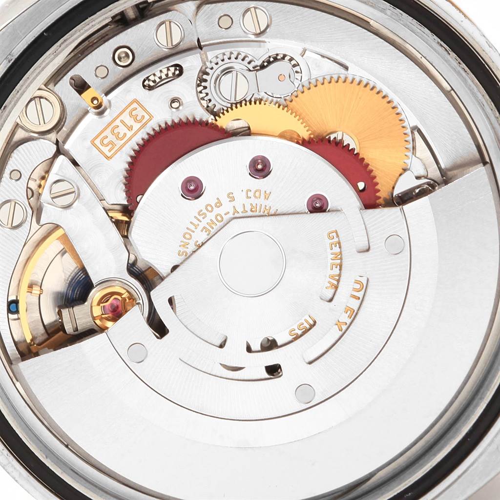This is a close-up view of the movement mechanism of a Rolex Datejust 116233 Men
s Stainless Steel Black Dial 116233 Men
s Stainless Steel Black Dial watch, showing gears and intricate components.