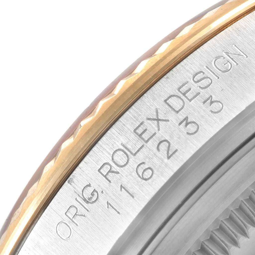 This image shows a close-up of the bezel and edge of the case on a Rolex Datejust 116233 Men's Stainless Steel Black Dial 116233 Men's Stainless Steel Black Dial watch, highlighting the engravings.