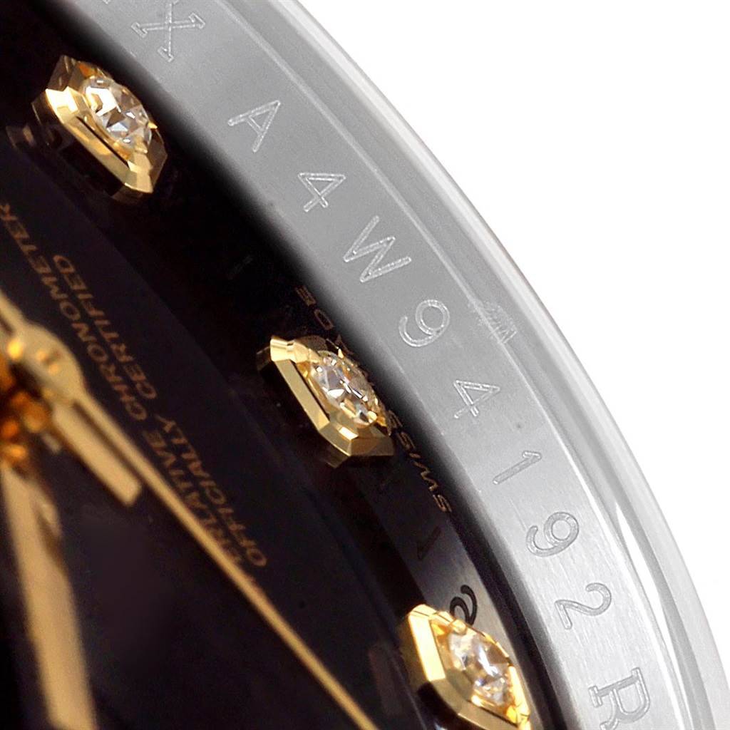 This image shows a close-up angle of a Rolex Datejust 116233 Men's Stainless Steel Black Dial 116233 Men's Stainless Steel Black Dial watch, highlighting its diamond hour markers and engraved serial number.
