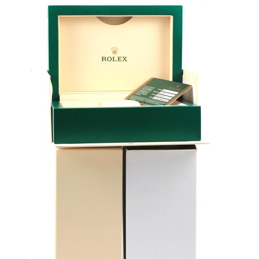 The image shows an open Rolex Datejust 116233 Men's Stainless Steel Black Dial 116233 Men's Stainless Steel Black Dial watch box with its warranty card placed inside.