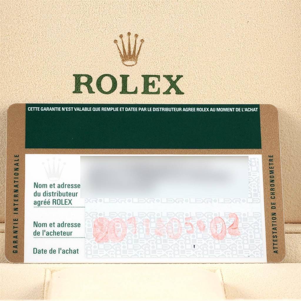 The image shows a Rolex Datejust 116233 Men's Stainless Steel Black Dial 116233 Men's Stainless Steel Black Dial warranty card with a green and gold design, displaying the name and date of purchase information.