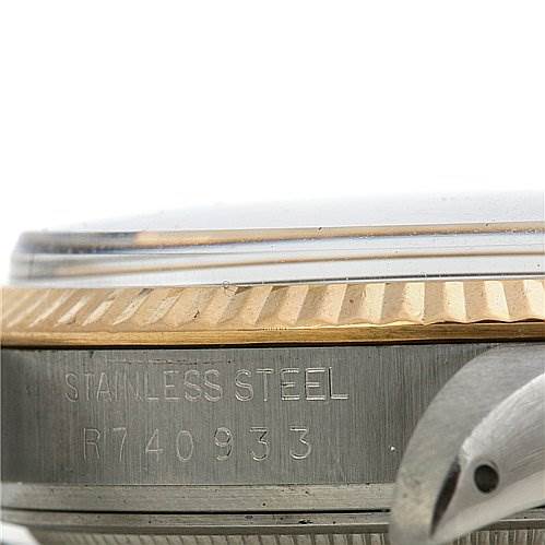 The image shows a close-up side view of the Rolex Datejust 16013 Men's Stainless Steel White Dial 16013 Men's Stainless Steel White Dial, highlighting its fluted bezel, part of the casing, and some serial engraving.
