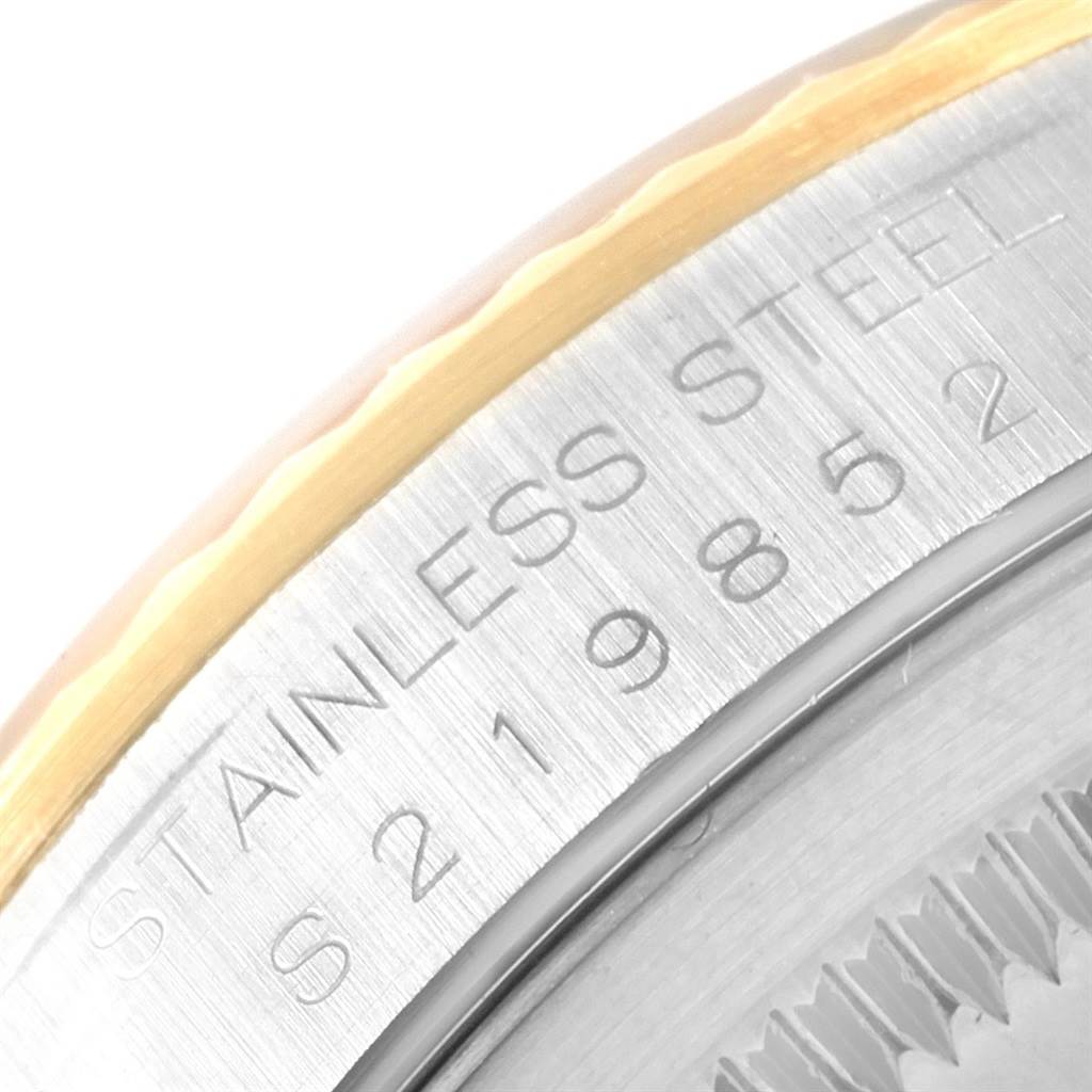 A close-up angle of the stainless steel and gold-tone bezel edge on a Rolex Datejust 16233 Men
s Steel and Gold (two tone) Black Dial 16233 Men
s Steel and Gold (two tone) Black Dial watch, showing part of the serial number.