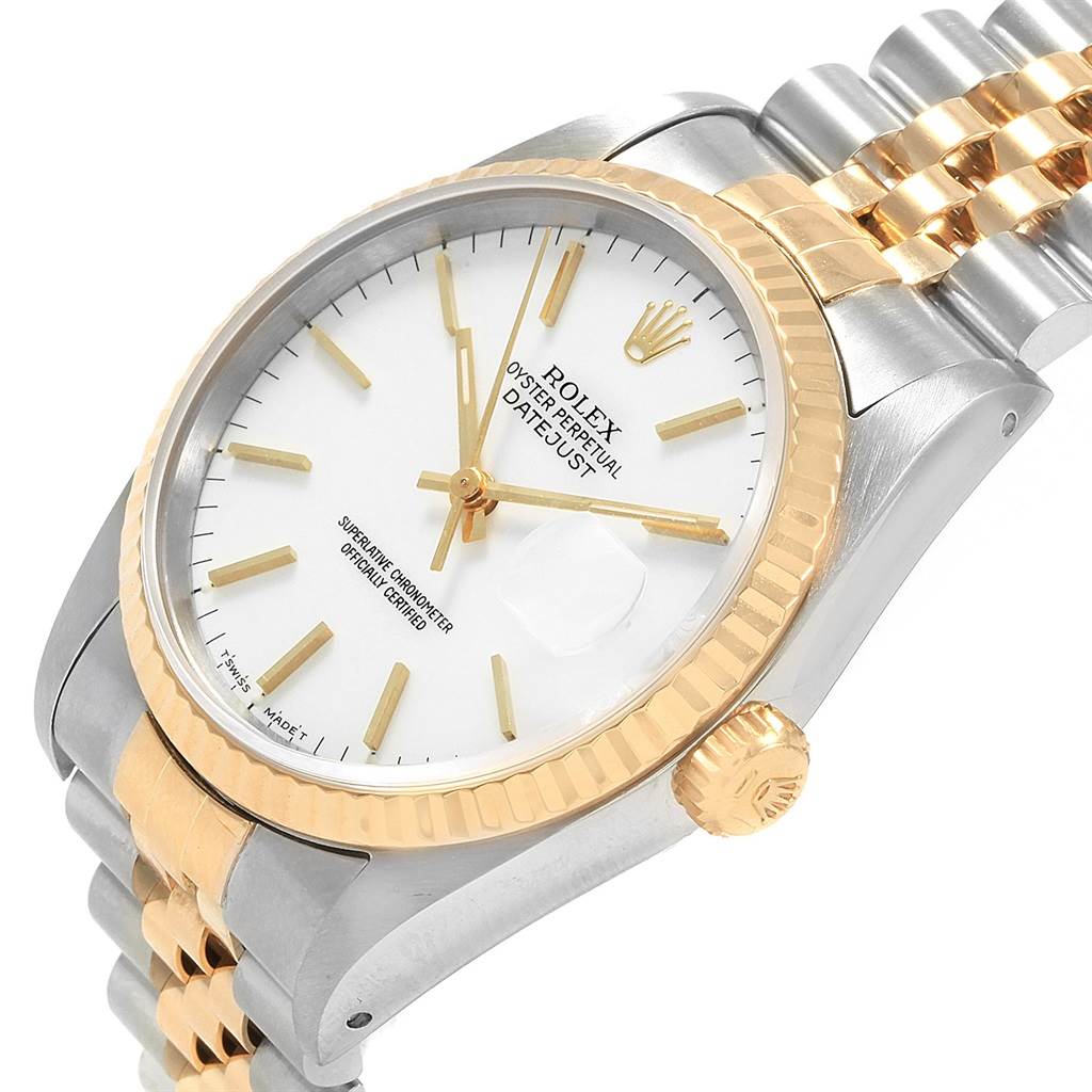This image shows a Rolex Datejust 16233 Men's Steel and Gold (two tone) White Dial 16233 Men's Steel and Gold (two tone) White Dial watch from a front angle, highlighting its white dial, two-tone bracelet, and fluted bezel.