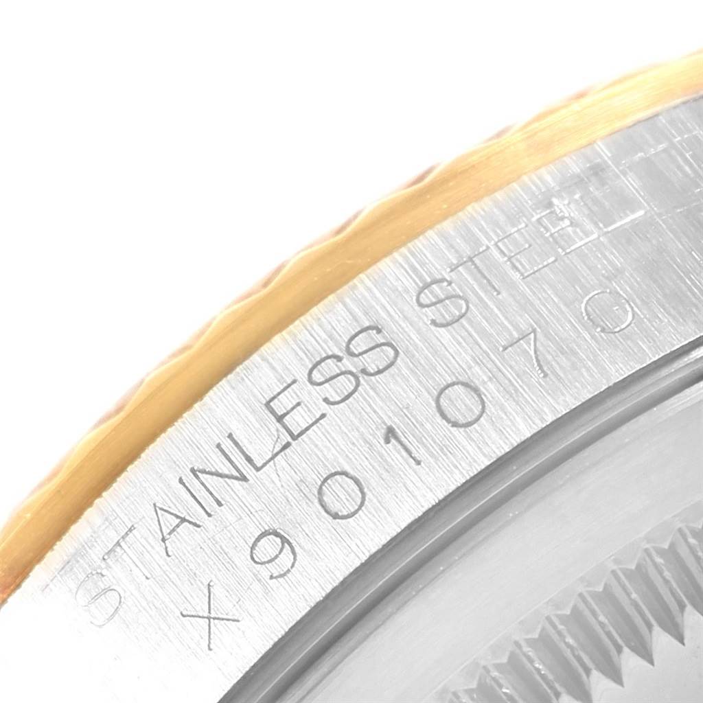 The image shows a close-up of the stainless steel and gold bezel with the serial number on a Rolex Datejust 16233 Men's Steel and Gold (two tone) White Dial 16233 Men's Steel and Gold (two tone) White Dial watch.