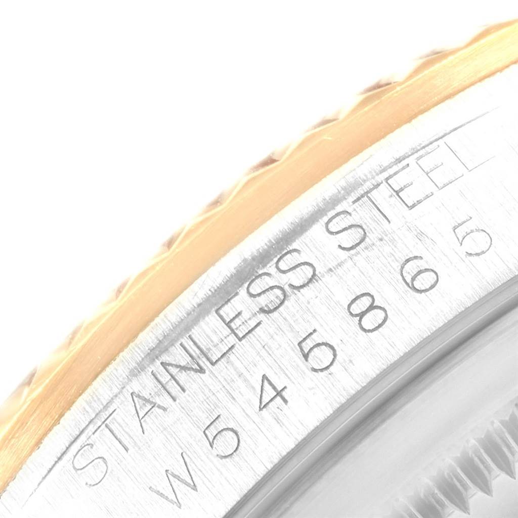 This is a close-up image showing the engraved case edge and part of the bezel of the Rolex Datejust 16233 Men
s Steel and Gold (two tone) Black Dial 16233 Men
s Steel and Gold (two tone) Black Dial.