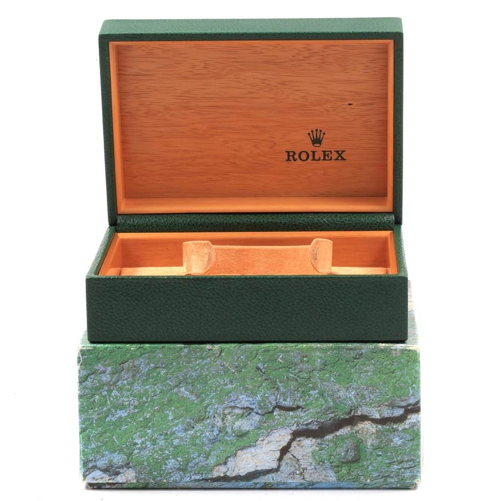 This image shows an open Rolex Datejust 16233 Men
s Steel and Gold (two tone) Black Dial 16233 Men
s Steel and Gold (two tone) Black Dial watch box with a green exterior and wooden interior.