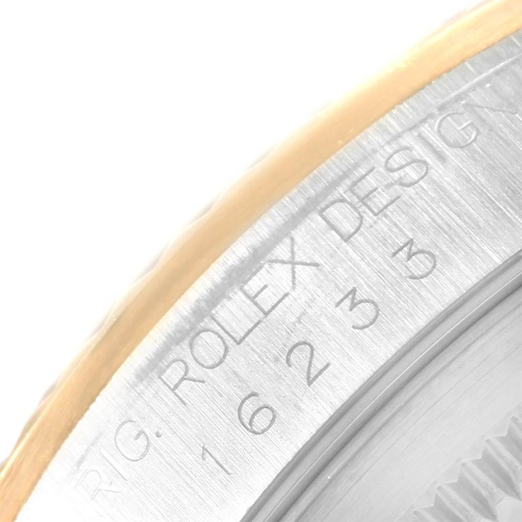The image shows a close-up of the side of a Rolex Datejust 16233 Men
s Steel and Gold (two tone) Black Dial 16233 Men
s Steel and Gold (two tone) Black Dial watch, highlighting the engraved text on the metal surface.