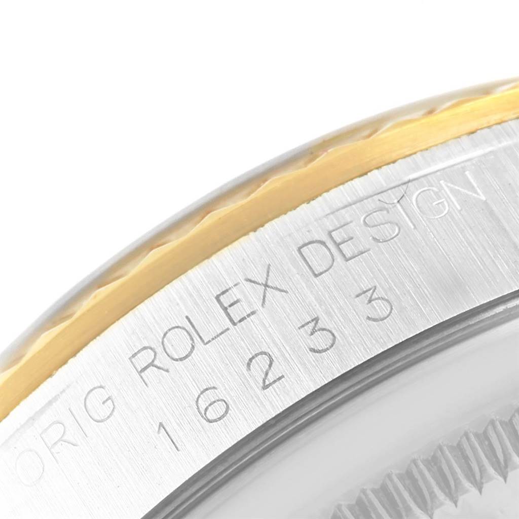 This image shows a close-up angle of the Rolex Datejust 16233 Men's Steel and Gold (two tone) Champagne Dial 16233 Men's Steel and Gold (two tone) Champagne Dial model, highlighting the bezel and engraved caseback.