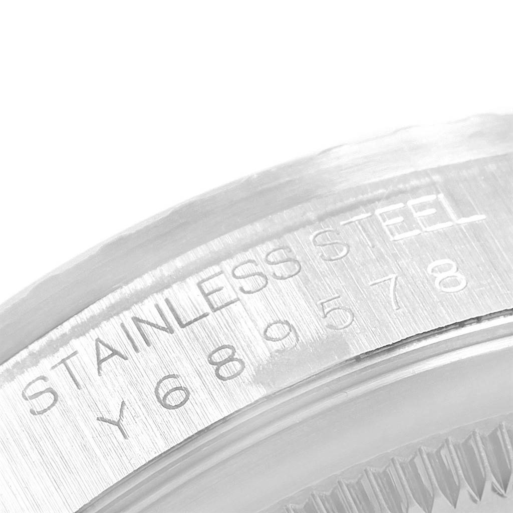 This image shows a close-up of the serial number and the "STAINLESS STEEL" engraving on the case of a Rolex Datejust 16220 Men's Stainless Steel Silver Dial 16220 Men's Stainless Steel Silver Dial watch.