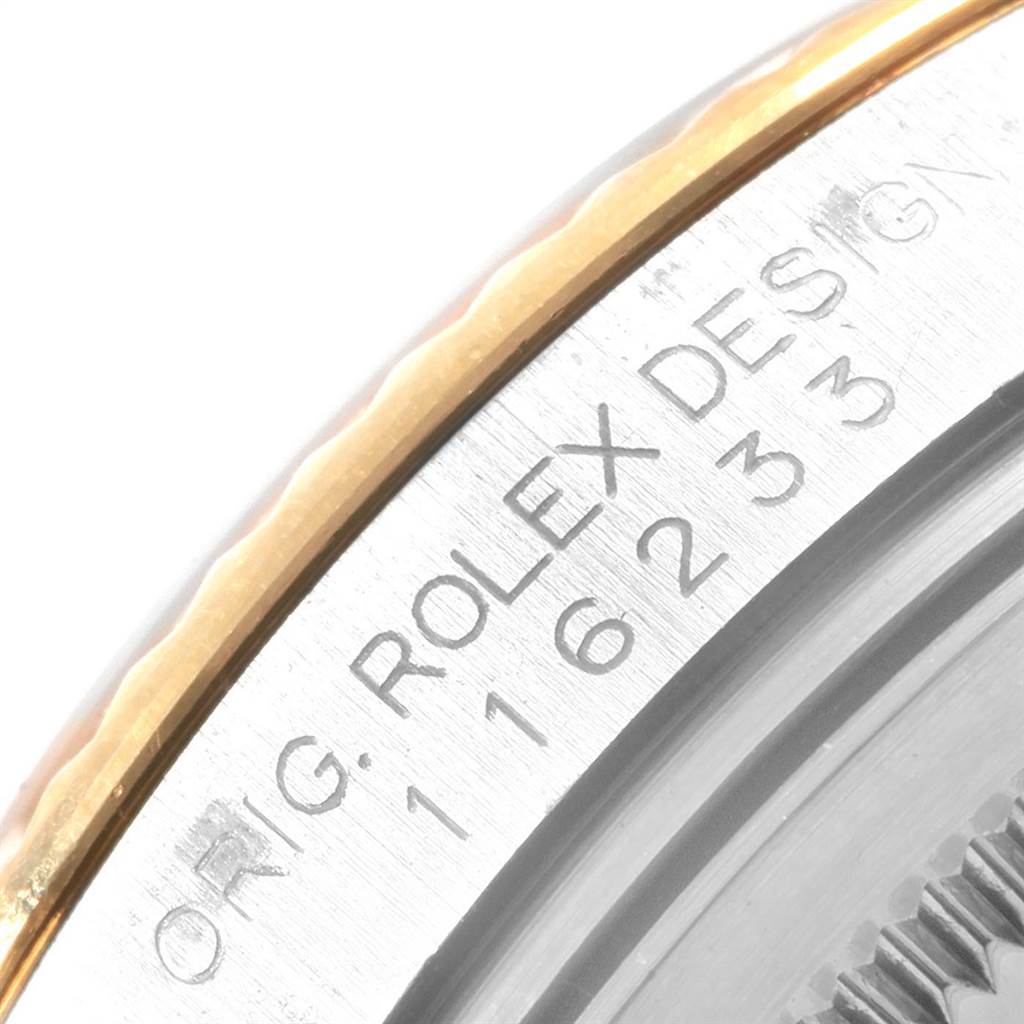 The image shows a close-up of the side of a Rolex Datejust 116233 Men's Steel and Gold (two tone) White Dial 116233 Men's Steel and Gold (two tone) White Dial watch, highlighting the bezel and model engraving.