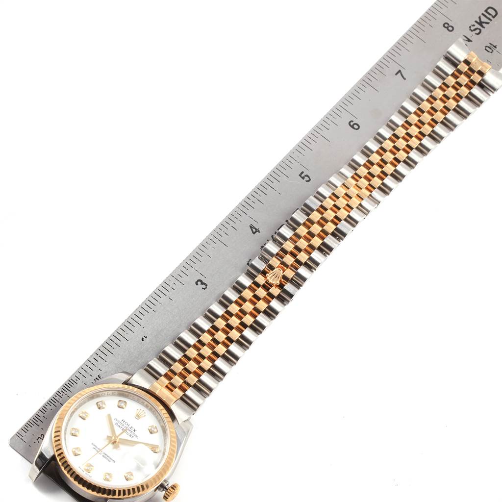 The image shows a Rolex Datejust 116233 Men's Steel and Gold (two tone) White Dial 116233 Men's Steel and Gold (two tone) White Dial watch lying flat, with a ruler measuring its two-tone bracelet.