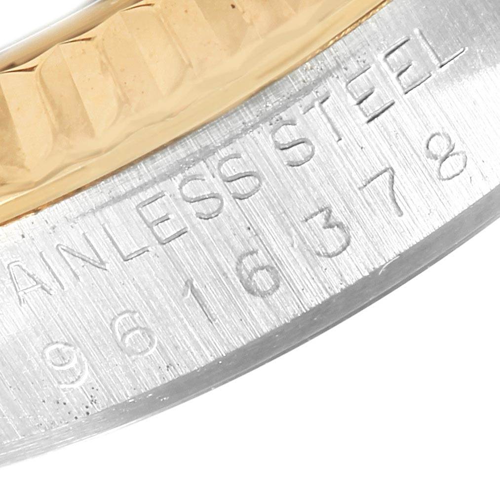 This close-up image shows the engraved bezel and case of a Rolex Datejust 16013 Men's Stainless Steel Champagne Dial 16013 Men's Stainless Steel Champagne Dial watch.