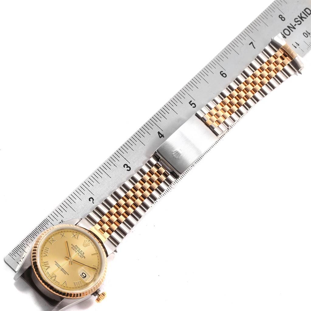 The image shows a Rolex Datejust 16233 Men's Steel and Gold (two tone) Champagne Dial 16233 Men's Steel and Gold (two tone) Champagne Dial watch laid flat, with a metal ruler measuring its two-tone bracelet.