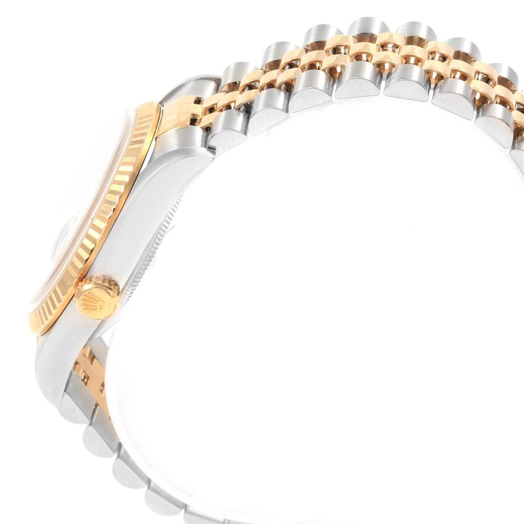 This side view of the Rolex Datejust 16233 Men's Steel and Gold (two tone) Champagne Dial 16233 Men's Steel and Gold (two tone) Champagne Dial watch shows the crown, bezel, and two-tone bracelet.