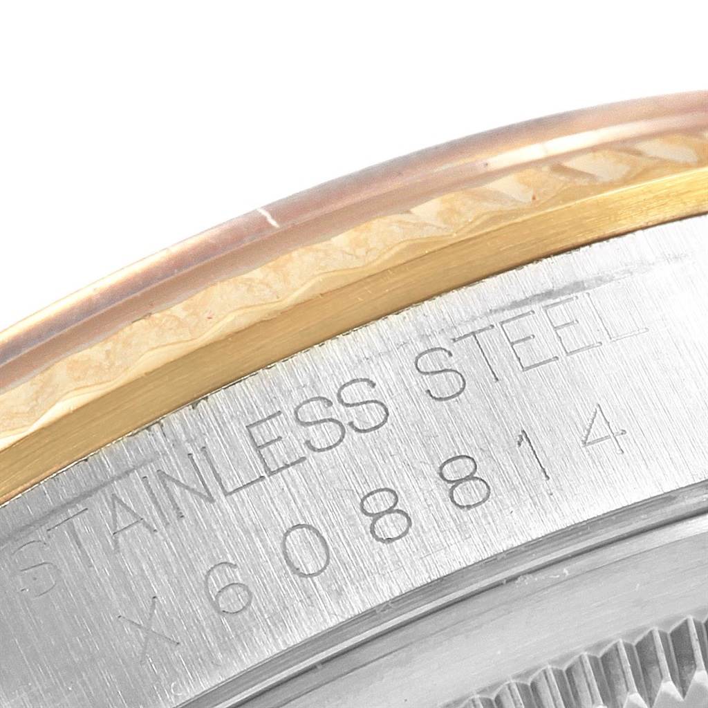 The image shows a close-up of the case back and part of the bezel of a Rolex Datejust 16233 Men
s Steel and Gold (two tone) Champagne Dial 16233 Men
s Steel and Gold (two tone) Champagne Dial watch.