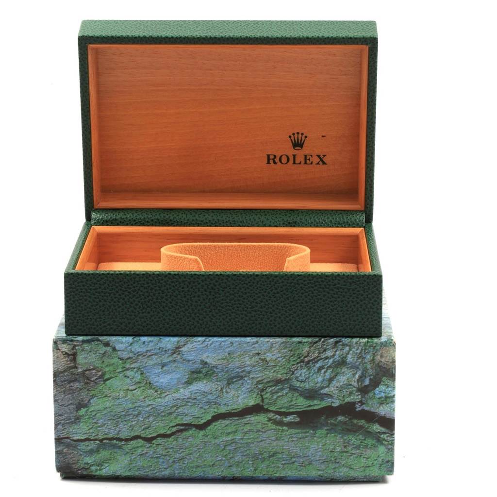 The image shows an open Rolex Datejust 16233 Men
s Steel and Gold (two tone) Champagne Dial 16233 Men
s Steel and Gold (two tone) Champagne Dial watch box from a front angle, displaying the interior cushion and green exterior.