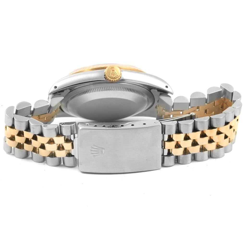 The image shows the back of a Rolex Datejust 16233 Men
s Steel and Gold (two tone) Champagne Dial 16233 Men
s Steel and Gold (two tone) Champagne Dial watch, featuring its clasp, crown, and jubilee bracelet.