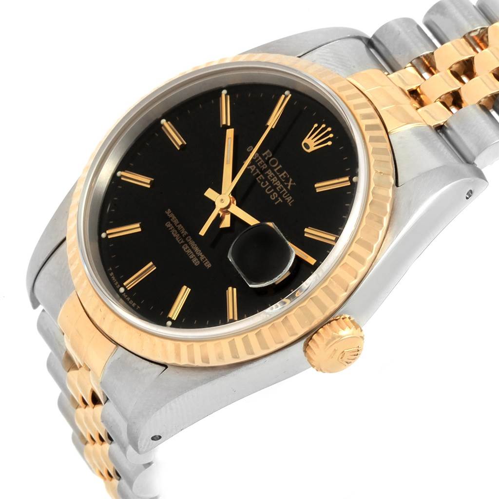 The image shows a close-up angle of a Rolex Datejust 16233 Men's Steel and Gold (two tone) Black Dial 16233 Men's Steel and Gold (two tone) Black Dial watch featuring its black dial, fluted bezel, and two-tone bracelet.