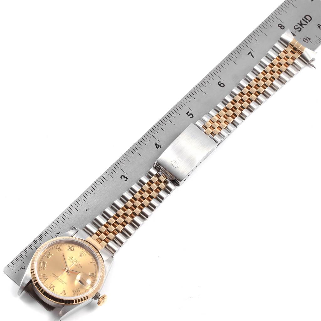 The image shows a Rolex Datejust 16233 Men
s Steel and Gold (two tone) Beige Dial 16233 Men
s Steel and Gold (two tone) Beige Dial watch laid flat next to a ruler, displaying its face, dial, crown, and Jubilee bracelet.