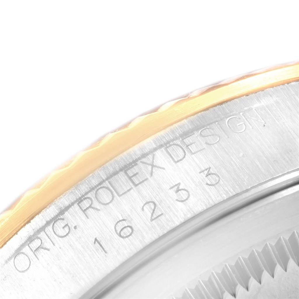 The image shows a close-up of the model and serial number engraving on the Rolex Datejust 16233 Men
s Steel and Gold (two tone) Beige Dial 16233 Men
s Steel and Gold (two tone) Beige Dial bezel.