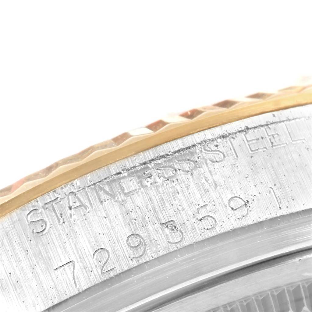 This close-up image shows the serial number and the textured bezel of the Rolex Datejust 16013 Men's Stainless Steel Champagne Dial 16013 Men's Stainless Steel Champagne Dial watch.