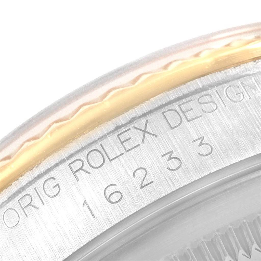 Close-up of the Rolex Datejust 16233 Men
s Steel and Gold (two tone) Champagne Dial 16233 Men
s Steel and Gold (two tone) Champagne Dial watch showing the bezel edge and engraved model number.