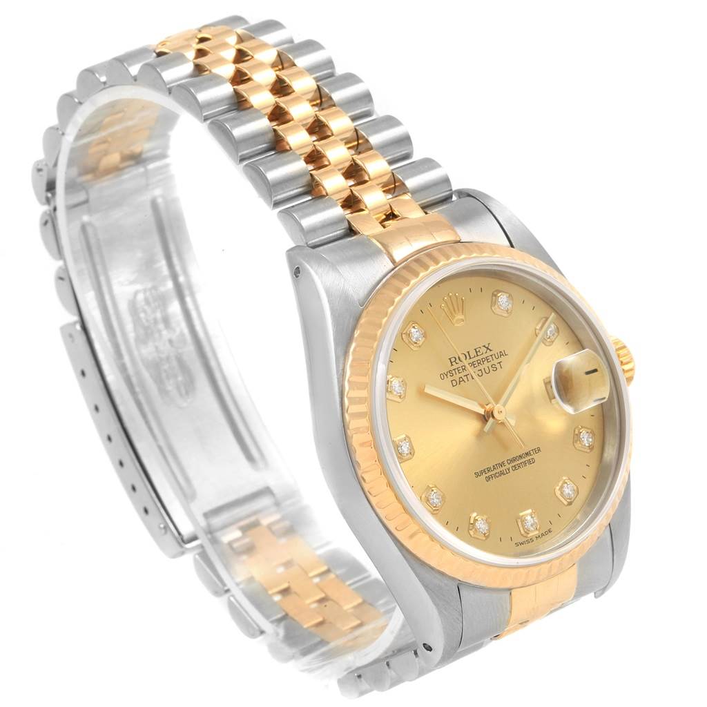 The image shows a Rolex Datejust 16233 Men
s Steel and Gold (two tone) Champagne Dial 16233 Men
s Steel and Gold (two tone) Champagne Dial watch with a two-tone metal band and a gold dial, viewed from an angled side perspective.